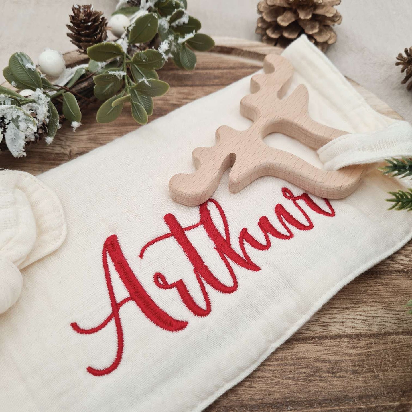 Detailed view of the embroidered baby's name on the Muslin Comforter.
