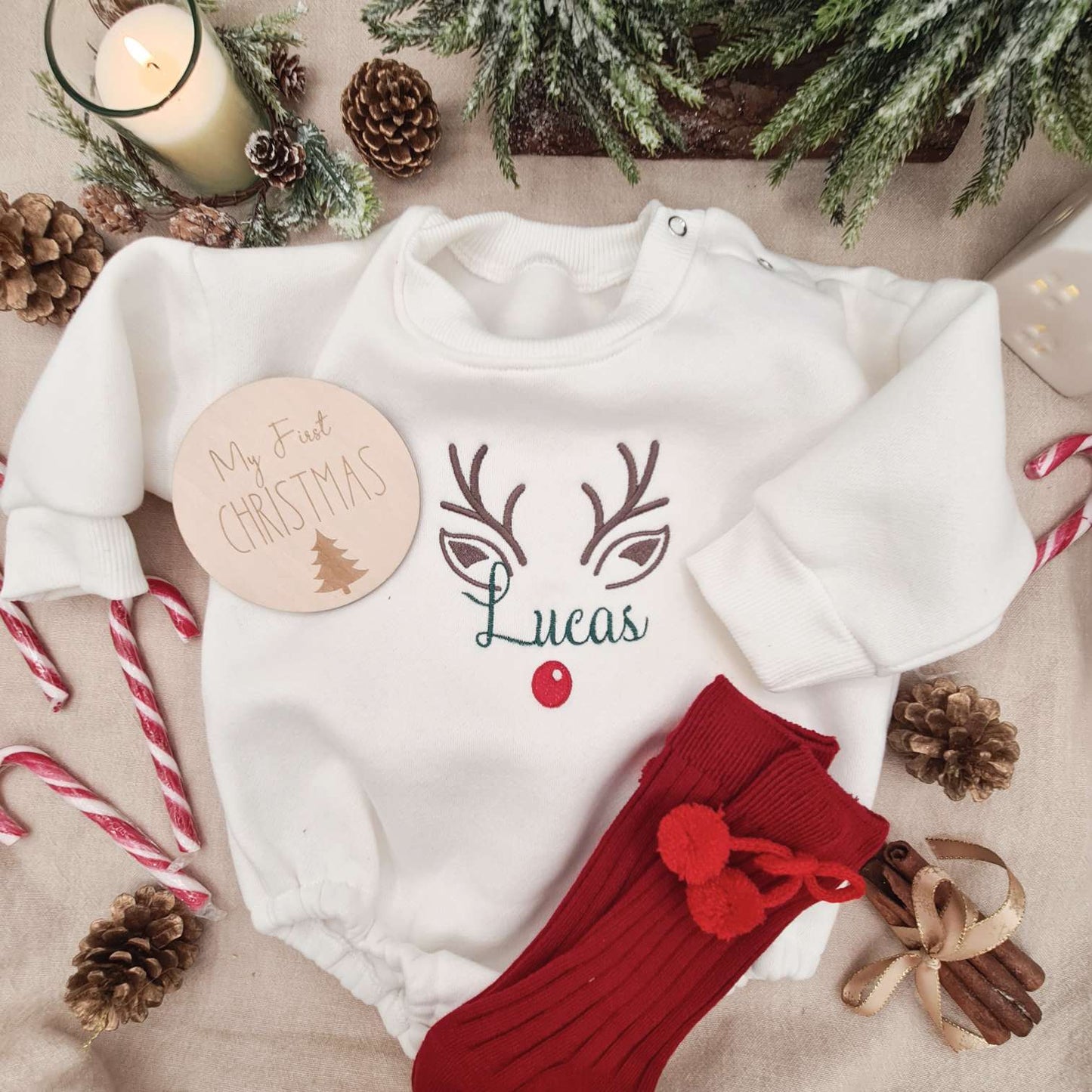Overall view of the off-white Baby Romper with embroidered reindeer for Christmas.