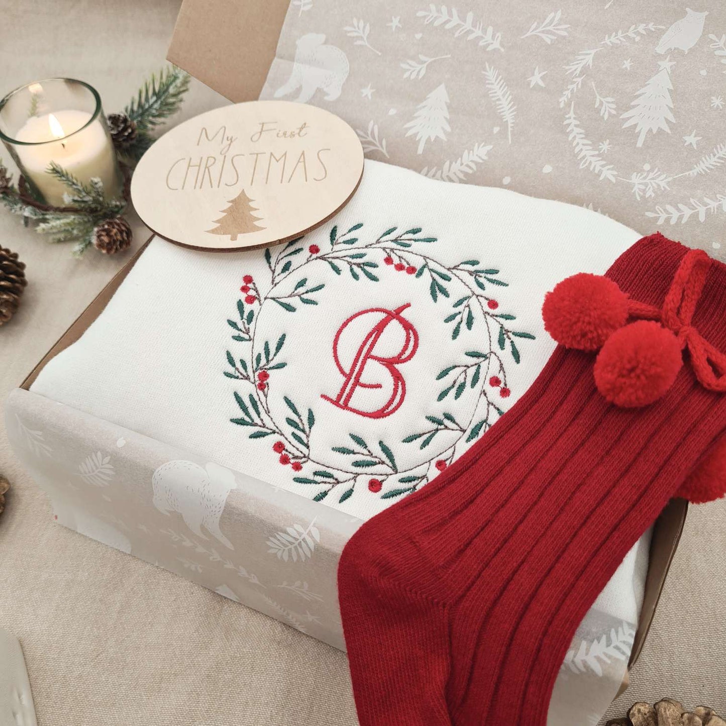 Festive setting featuring the Monogrammed Christmas Wreath Baby Romper.