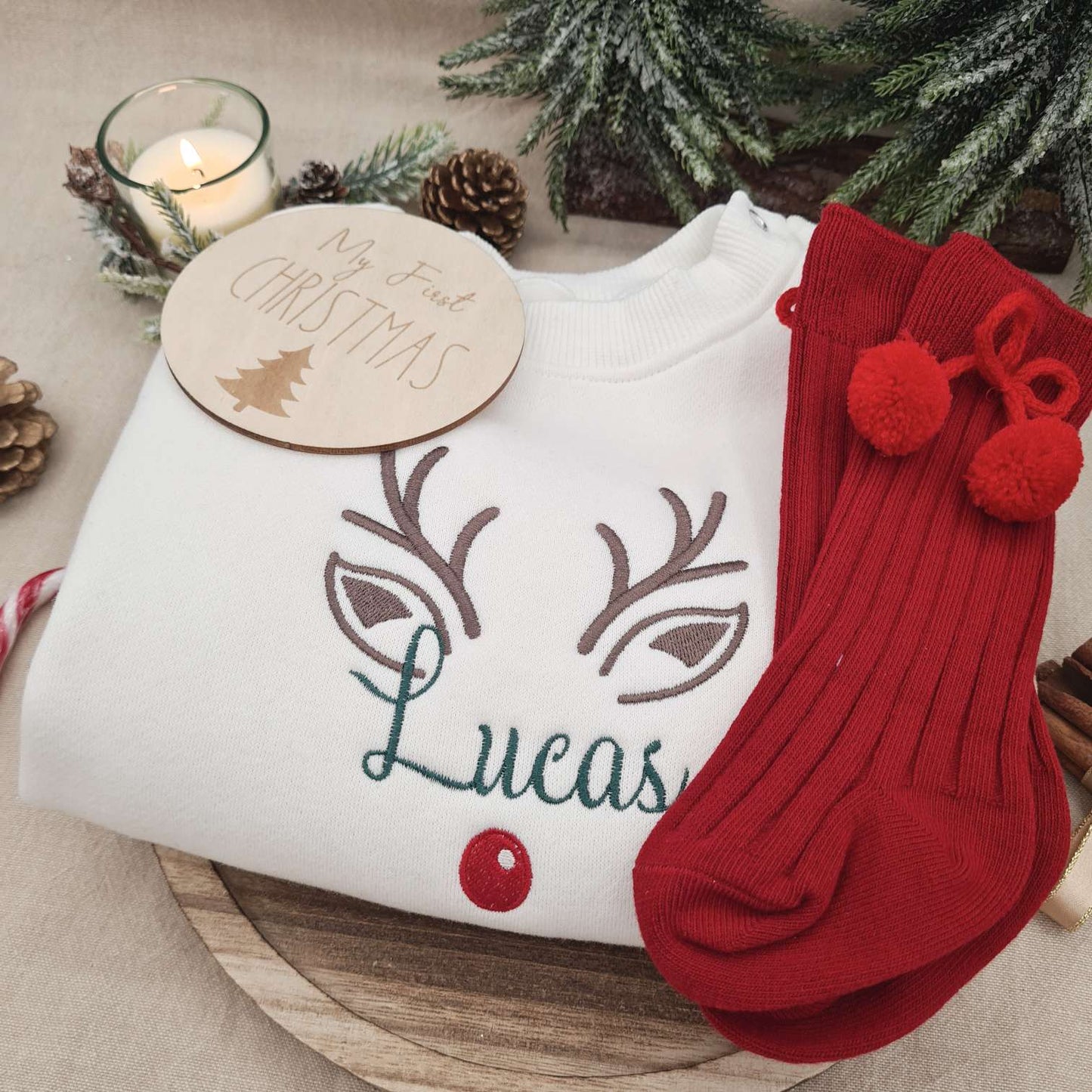 Custom name embroidery on the First Christmas Baby Romper with reindeer design.