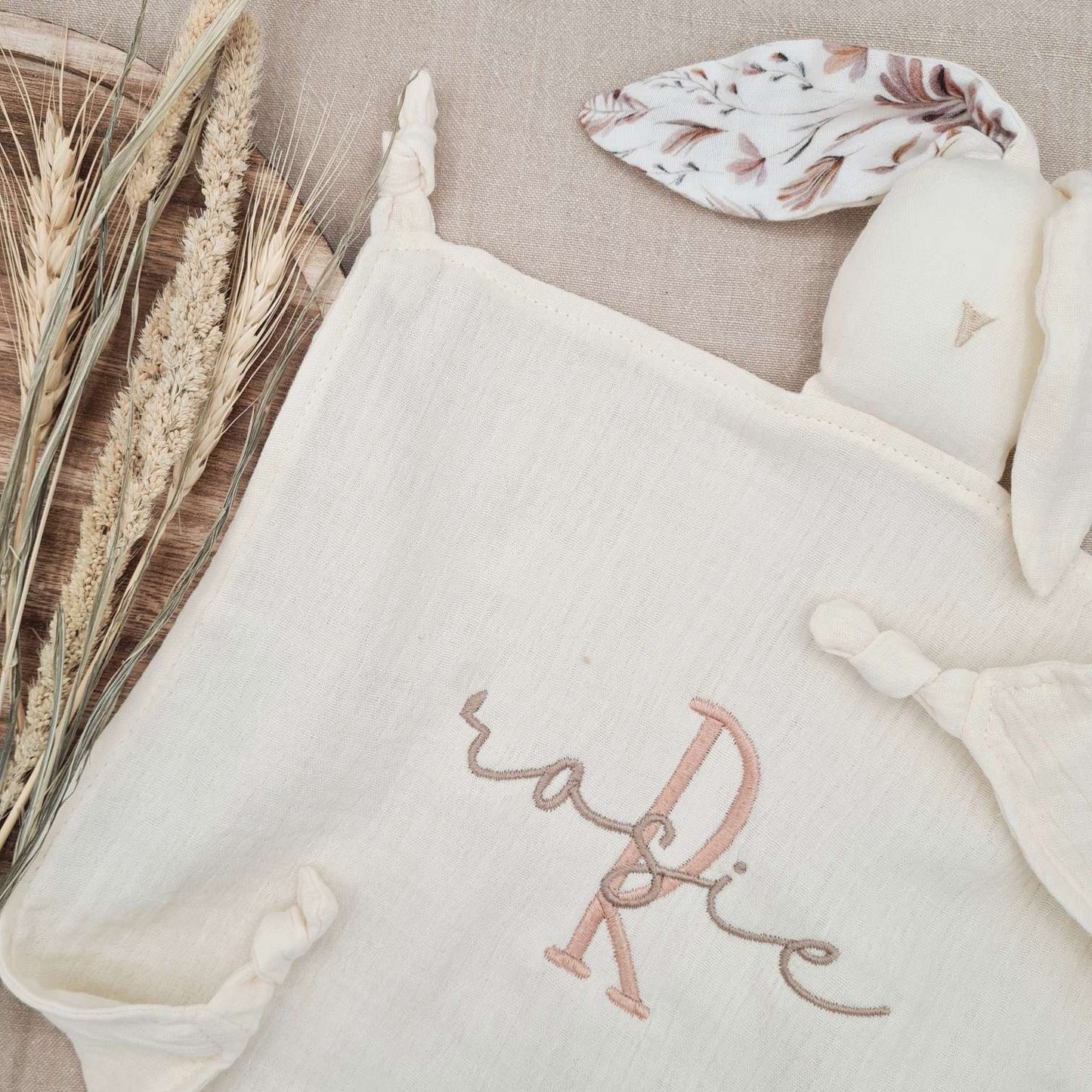 Personalised ivory baby comforter with floral-patterned bunny ears, embroidered with name 'Rosie'. Gentle comforter for newborns.