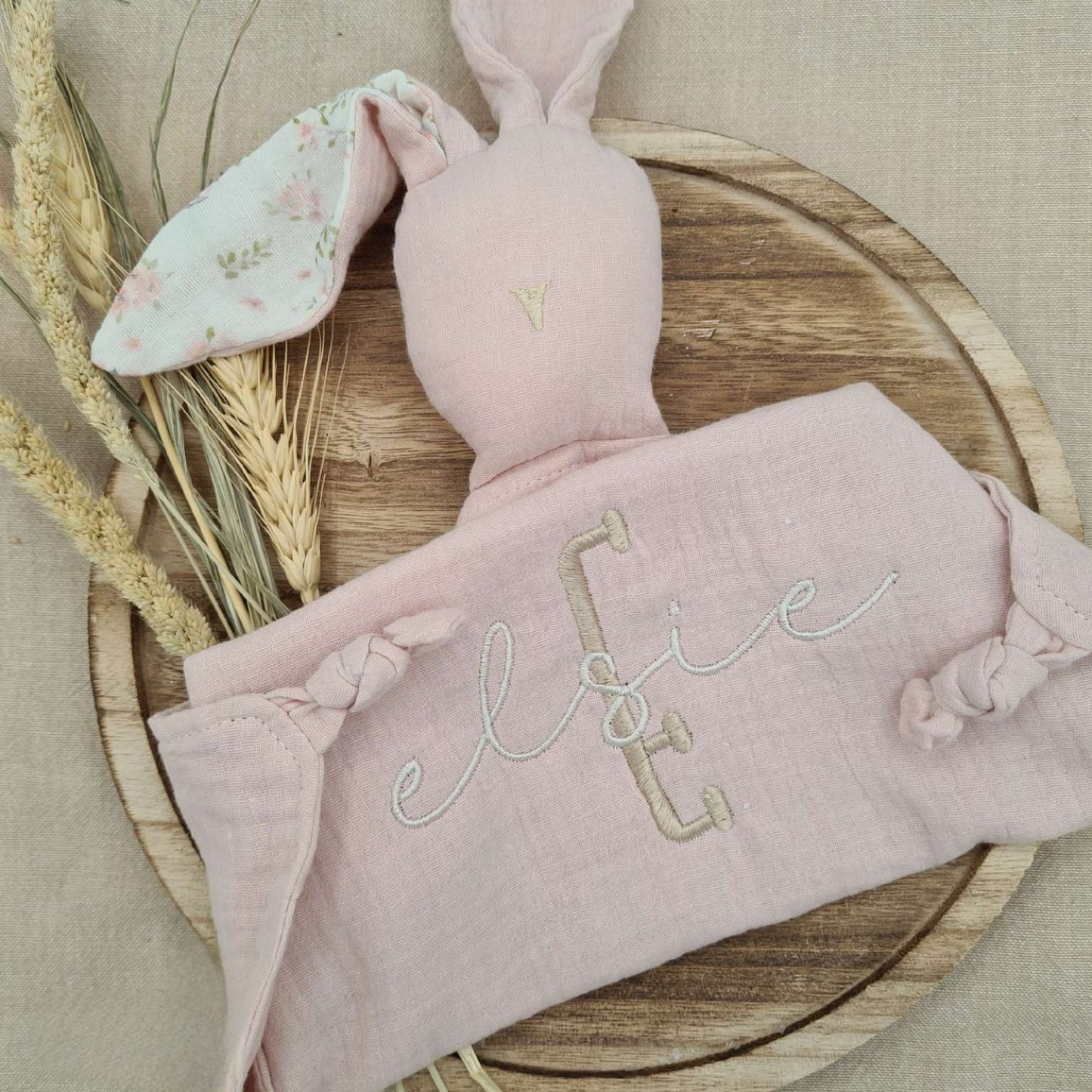 Light pink baby comforter with bunny ears, personalised with embroidered name 'Elsie'. Soft and comforting for little hands.