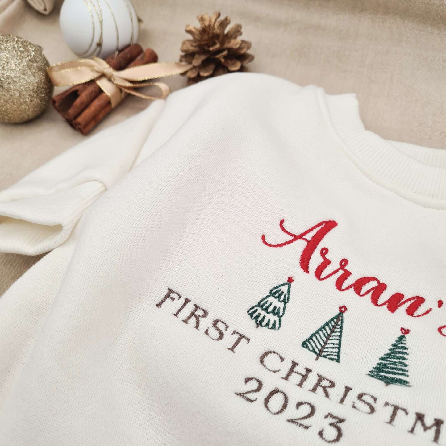 Close-up of the personalized name embroidery on the First Christmas 2023 Baby Romper.