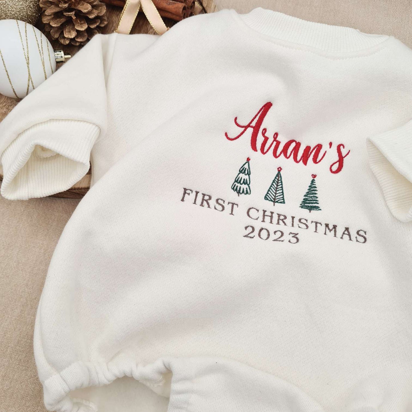 Side angle of the Embroidered Baby Romper highlighting the fleece texture.