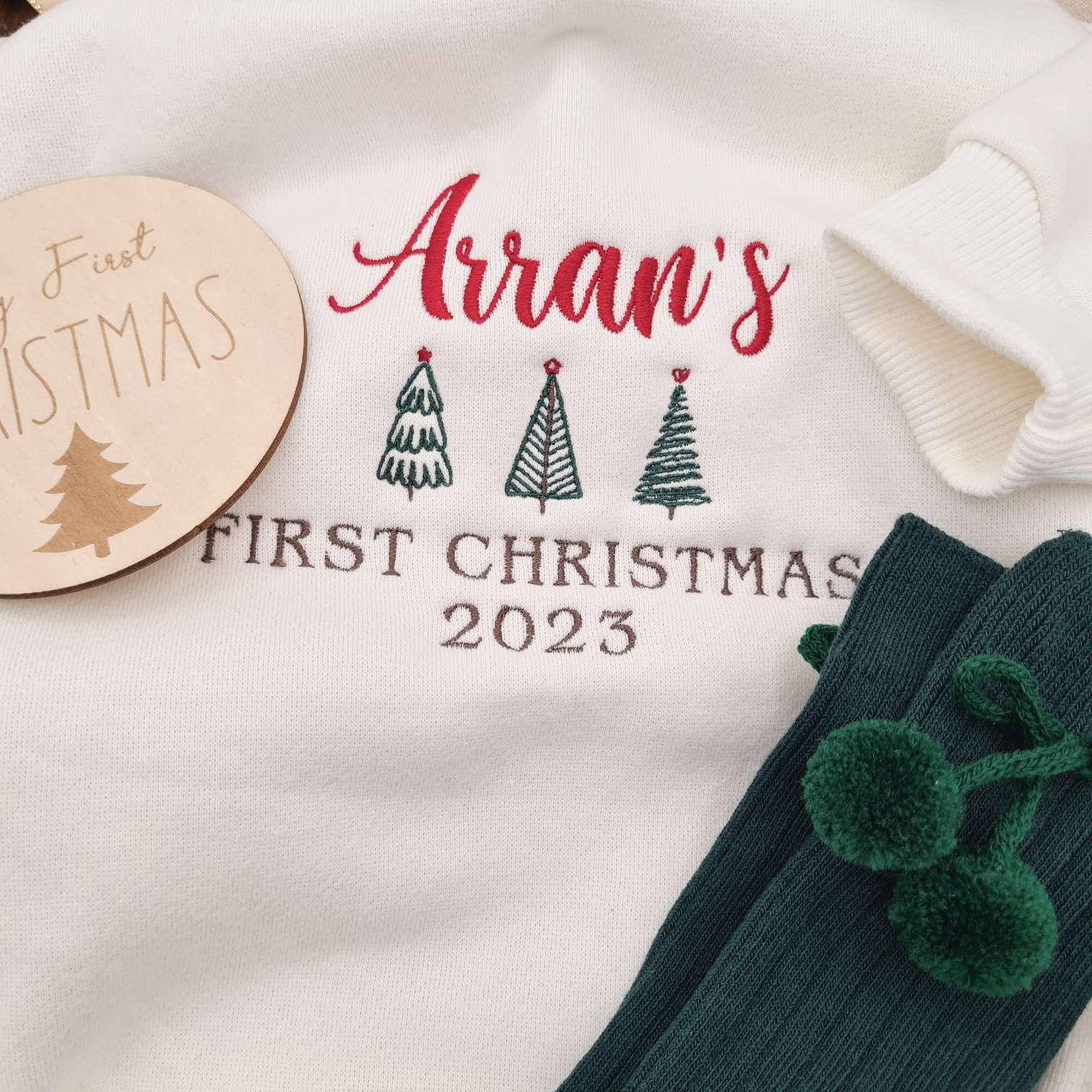 Close-up of the personalized name embroidery on the First Christmas 2023 Baby Romper.