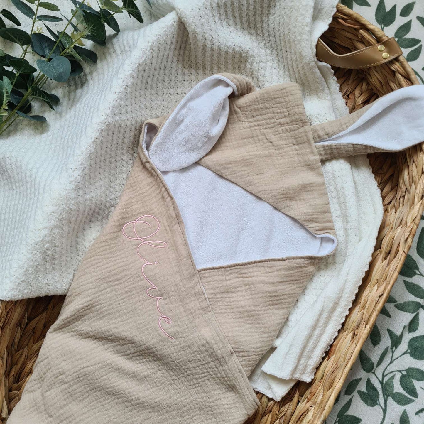 Beige personalised hooded baby towel with bunny ears and embroidered name 'Olive'. Made from soft muslin and terry cotton.