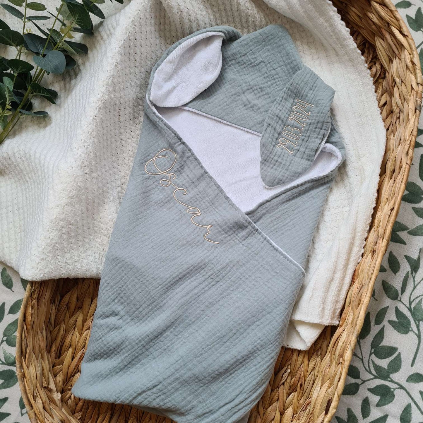 Green personalised hooded baby towel with bunny ears and embroidered name 'Oscar'. Made from organic cotton muslin and terry for softness.