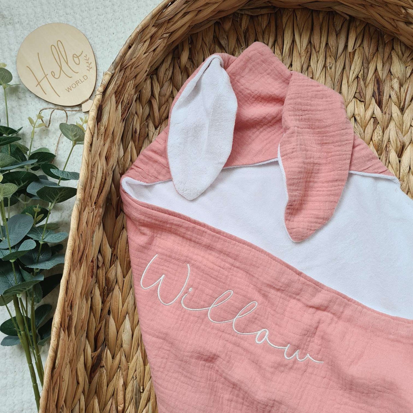 Pink hooded baby towel with bunny ears and embroidered name 'Willow'. Made from soft muslin and terry cotton for gentle care.